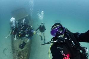 Open water course students learning to dive on a Boat